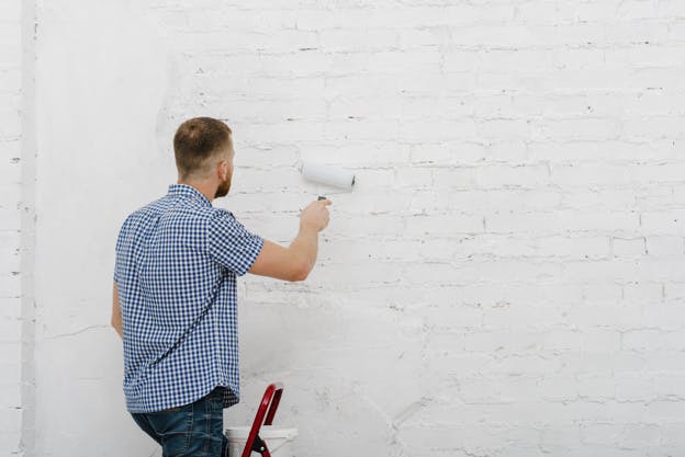 man painting a wall